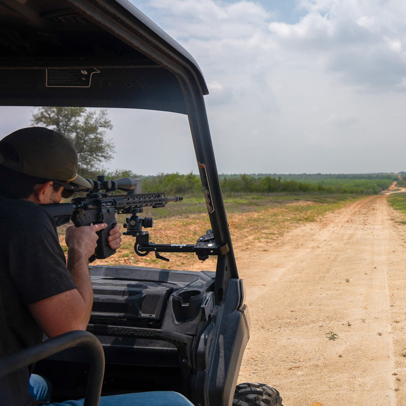 Hub clamped to a UTV roll cage with a spotting scope on top