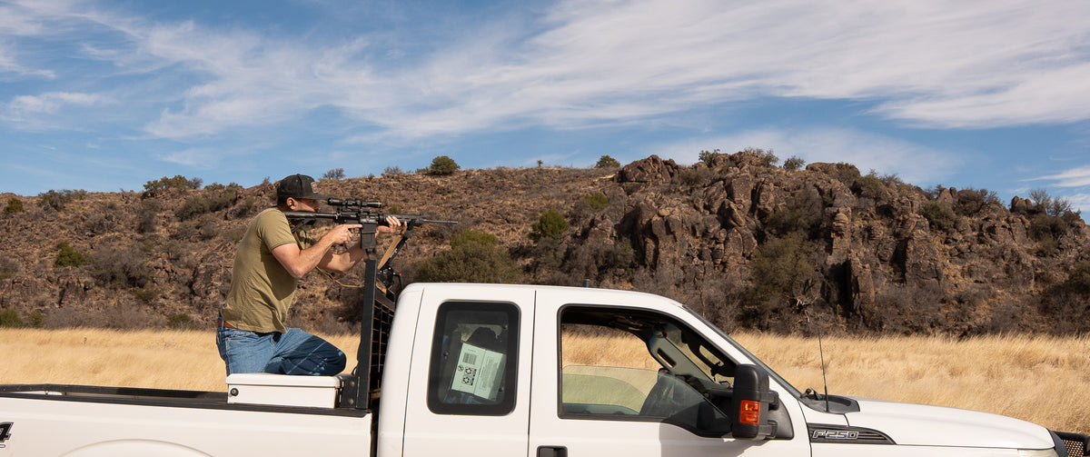 Trunk mounted hunting shooting rest for ate and itv connect aim mounted to white f250 truck